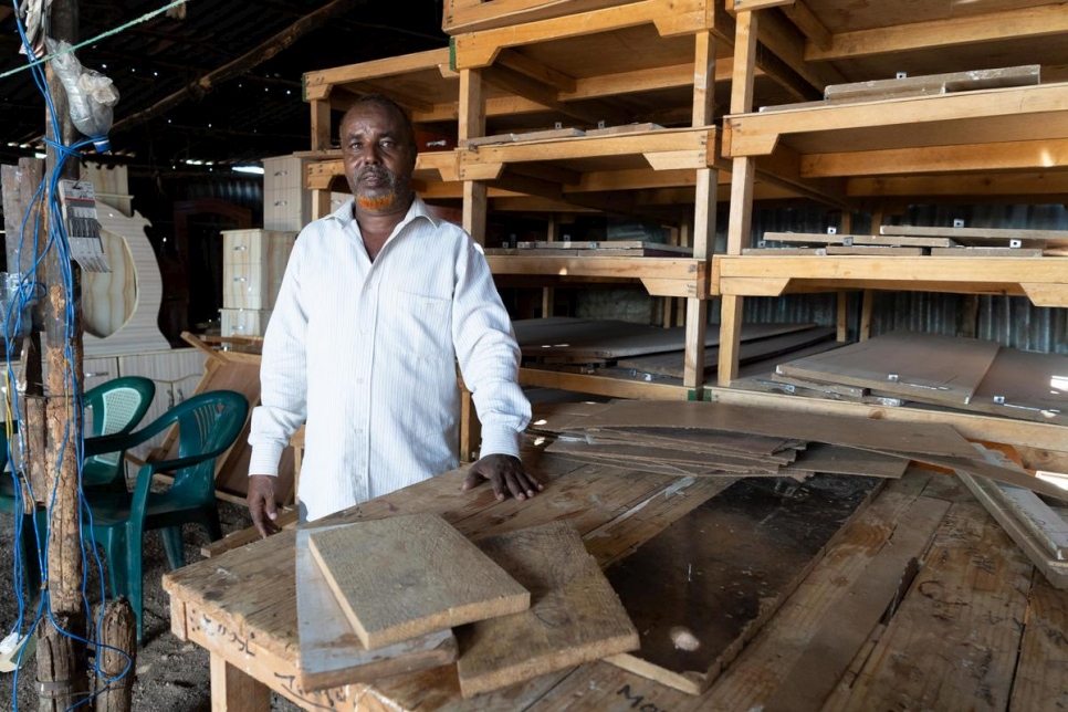 Somali refugee, Musa Yussuf Burey stands inside his furniture workshop in Melkadida, Ethiopia.