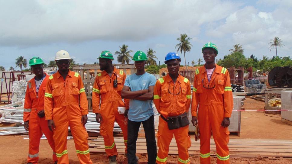 Amos and Allen (far right) stand together with their colleagues at Consar Ghana Limited's project site.