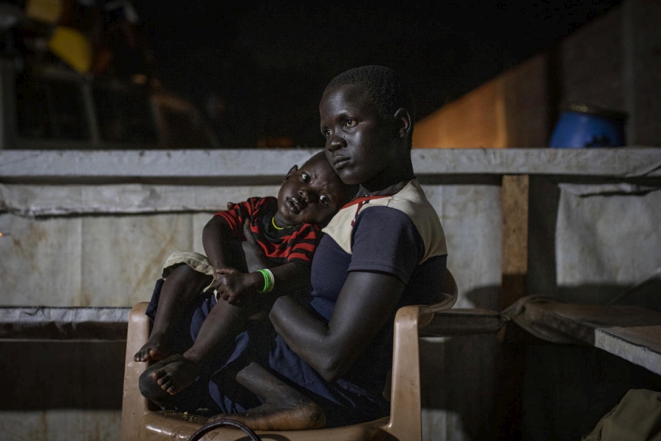 Democratic Republic of Congo. A newly arrived South Sudanese refugees mother holds her baby boy as they wait to receive a meal and accommodation at the transit centre in Aru