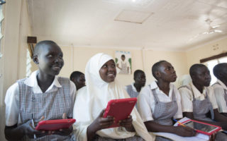 Girls sit in a school