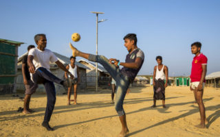 Young boys play soccer