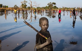 Yacob Ibrahim, a 10-year-old refugee from the Nuba Mountains in Sudan, fishes in a lake near Yida, South Sudan. Yacob’s family fled Sudan three years ago and now live in Yida with thousands of other refugees. Like most of the children fishing here, he uses a stick to strike the fish when they surface. “This is a job for me. I do it to buy pens and exercise books for school,” he says. “I fish on weekends and sometimes during the week.”