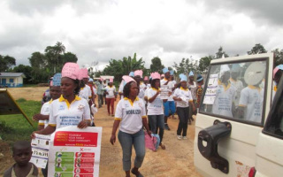 Volunteers go round Bahn Refugee Camp, knocking on doors and advising people to wash their hands as a precaution against the Ebola virus.