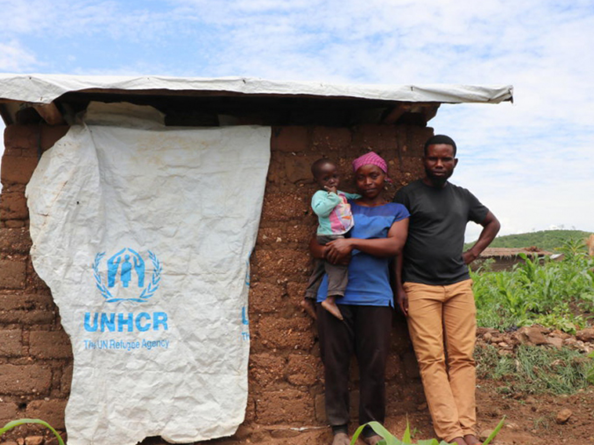 A family stands next to a toilet