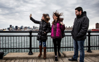 Kevork and his sisters take pictures of the Montreal skyline.