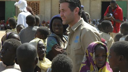 Chad / Khaled Hosseini, author of the best-selling novel The Kite Runner is welcomed by a group of children in Kounoungou refugee camp, eastern Chad. Hosseini was last year named a Goodwill Envoy for the UN refugee agency in the USA. / UNHCR / T. Irwin / February 2007