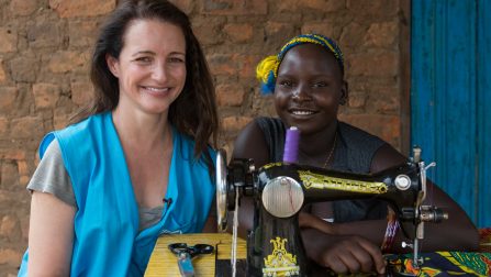 UNHCR High Profile Supporter Kristin Davis spends time with Fiona Taba (18) a South Sudanese refugee who's become a tailor and a fashion designer. Fiona also cultivates a plot of land that was donated by the Ugandan Governmnet at the Rhino Base camps settlement.