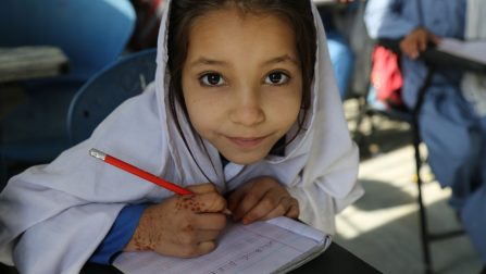 An Afghan refugee girl, Samina is keen to learn English. She wants to be a teacher when she grows up at Kot Chandana refugee village in Mianwali, Pakistan. Samina is one of Aqeela’s student and highly inspired by her teacher who pioneered girls’ education at Kot Chandana Refugee Village. ; Aqeela Asifi won the UNHCR Nansen Refugee Award in 2015 for her dedication and hard work in bringing an education for refugee girls, who, before her arrival in the camp in 1992 did not even have a name for a female teacher. Thanks to Aqeela’s hard work, today, there are 09 primary and middle schools (4 for boys and 5 for girls) in Kot Chandana refugee camp with some 1,400 student (boys 831, girls 594) enrolled in these schools. Pakistan continue to host 1.5 million Afghan refugees, which is the world’ largest protracted refugee population till this date. Children under the age of 18 constitute 51 per cent of the total registered refugee population in Pakistan. Globally 2.6 million Afghan refugees are living in up to 92 countries and around 95 per cent of the population is hosted by just two countries: Islamic Republic of Pakistan and the Islamic Republic of Iran.