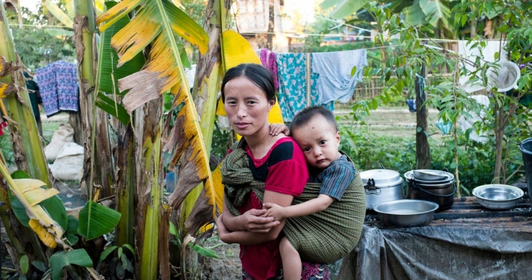 A mother cradles her child inside a camp for internally displaced people in Kachin State, Myanmar, in November 2013.