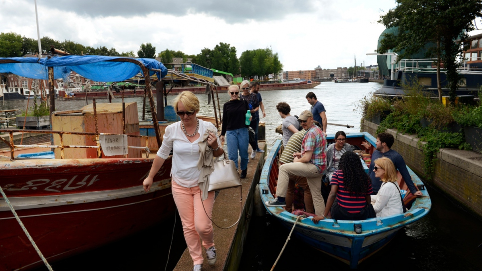 Boats used by refugees to reach safety in Europe are now being repurposed as tour boats on the canals of Amsterdam, with refugees serving as guides. The "Mister Friday" (left) once carried 282 refugees and migrants across the Mediterranean, while "Hedir" (right), meaning "Stormy Weather," carried 76.