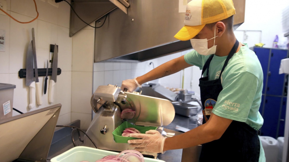 César cuts and prepares onions for the day at Sierra Nevada.