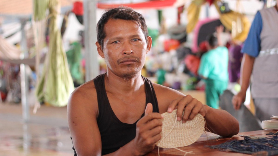 Baudilio Centeno weaves a basket at Pintolandia Shelter in Boa Vista, Brazil. He came from Tamacuro with his family and around 700 other Waraos when food and medicine ran out.