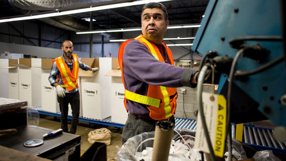 Syrian workers box up products at the Danby Appliances warehouse.