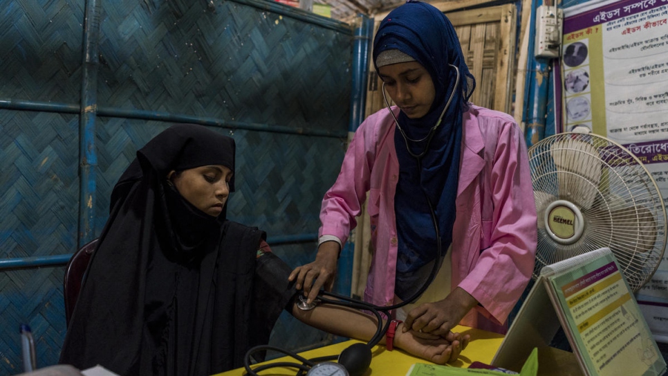 An expectant refugee mother receives a medical check at a primary healthcare centre at Kutupalong refugee settlement, Bangladesh. 