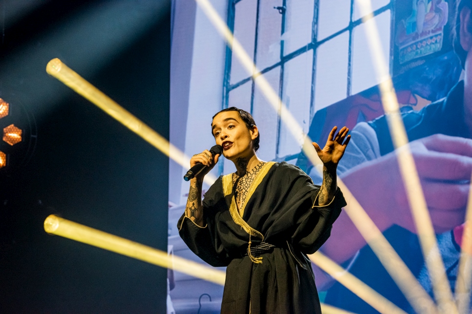 Swiss-Algerian singer-songwriter Amina Cadelli, aka Flèche Love (Arrow Love), performs her song, Sisters during the ceremony. 