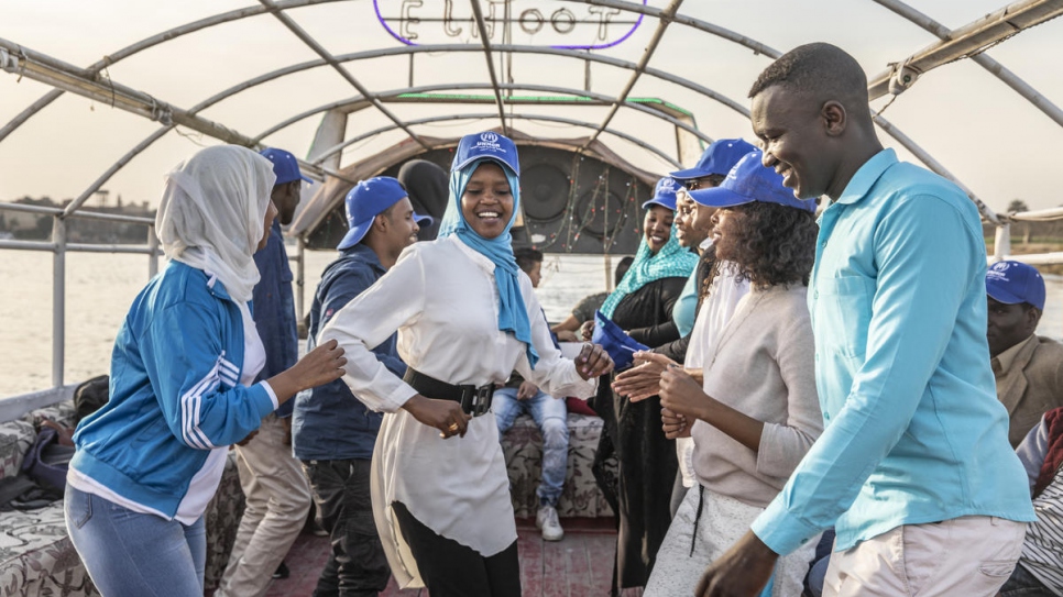 Mawadda (centre) and Omar (right) relax on a boat after the clean-up is over.