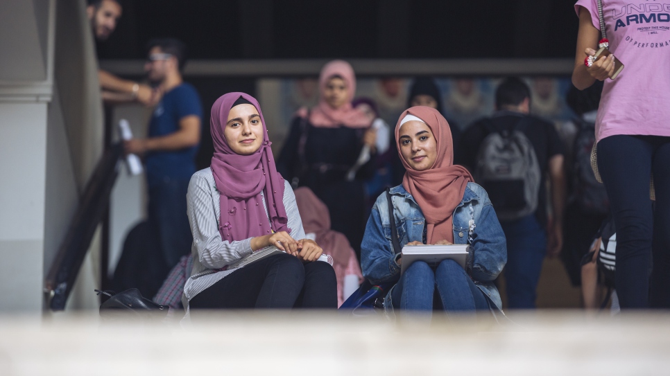 Weam (left), 19 years old; student in Computer Science (first year) at Lebanese University (UL), on a DAFI scholarship; from Dara'a, Syria; in Lebanon since 2015; interviewed on 03 October 2018 on UL Hadath Campus in Beirut.


On the right is Weam's friend, Diala, a first-ydear Biology student, also on a DAFI scholarship.

Weam: "We came to Lebanon in the summer of 2015. I entered my final year of high-school here in Lebanon but the classes were in English, which was a very big challenge. I learned mostly online, by myself. I also had to face some degree of exclusion then as I was the only Syrian student. 

During my first year at university, I took Physics, but then I changed to Computer Science. I have just started actually.

My parents, my two brothers and my sister live in Batroun, north of Beirut. I live here by myself, in a student dorm. I am the oldest one. My mother is a nurse and my father is a religious teacher. 

I feel very happy to be given the chance to study at university, as it is the road towards independence. 

Life on campus is both beautiful and tiring at the same time. I get to meet a lot of new people. Since I have started my college studies, I have become stronger, in terms of my personality as well as in the area of decision-making. 

At the moment I am learning English, French, Greek and Turkish. 

On the weekends, I like to play football and tennis, and to walk in the forest. I also love video games. My professional goal is to work in the field of programming or gaming, as a manager. But it will not be easy: first, I will need to financial means to do so and secondly, there are not too many gaming companies in the region. That means I will probably have to go abroad to pursue my career goals. 

My message to everyone listening is that one has to put in a lot of willpower and hard work to achieve one's dreams."