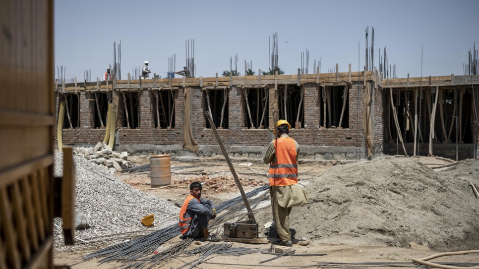 Construction workers build a primary school in Qarabagh, funded by UNHCR.