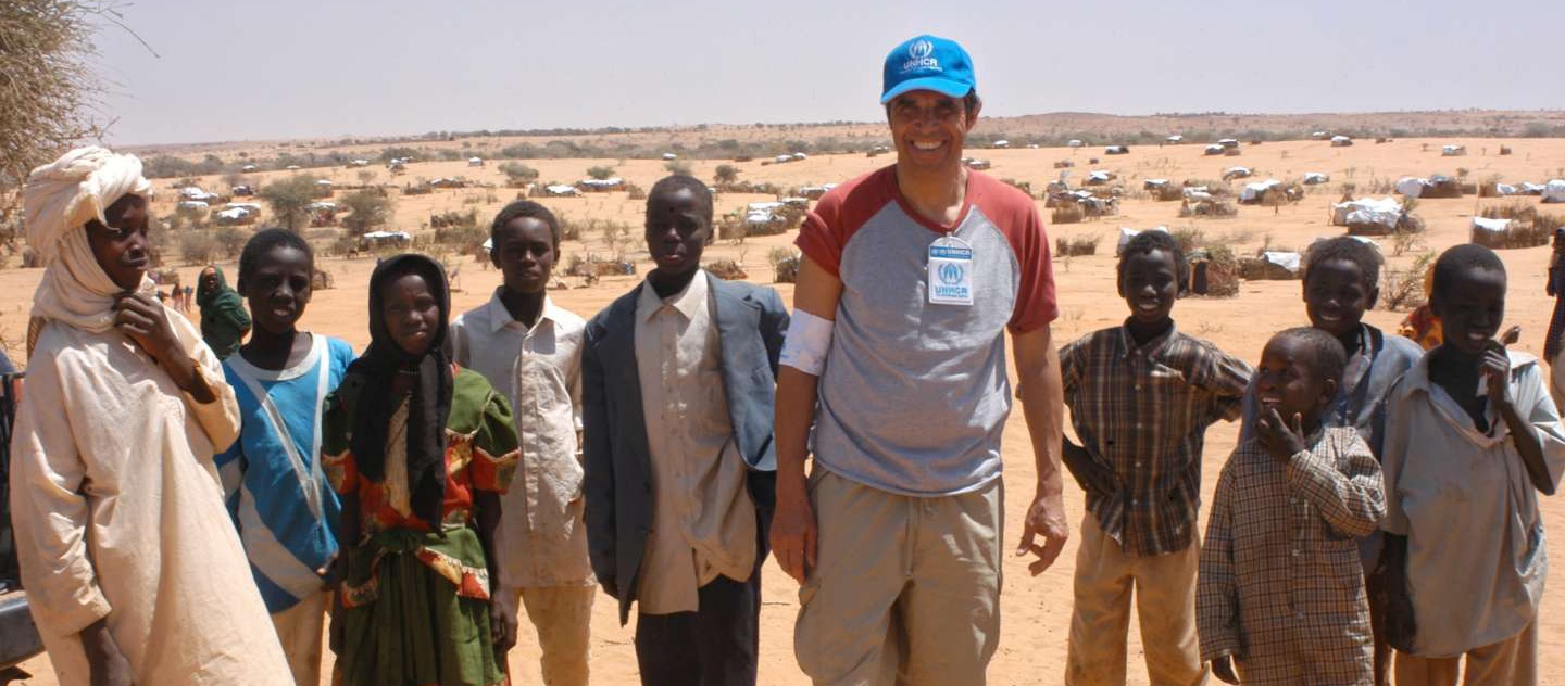 UNHCR Goodwill Ambassador Julien Clerc with Sudanese refugee children in Touloum, Eastern Chad. The camp started to receive refugees who were in Tine on February 7. As of March 4, there are 4,803 refugee in Touloum, which is located 17 km south east of Iriba. This is the first mission of Julien Clerc to the field as UNHCR Goodwill Ambassador. Touloum, March 4, 2004. / UNHCR / H. Caux    