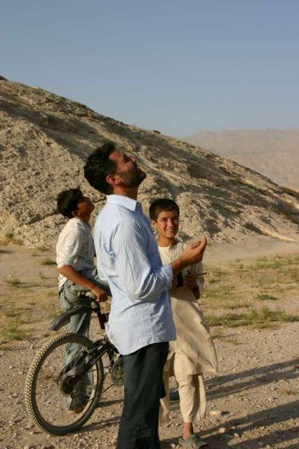 Khaled Hosseini flies kites with children at the Samangan caves in Balkh province.