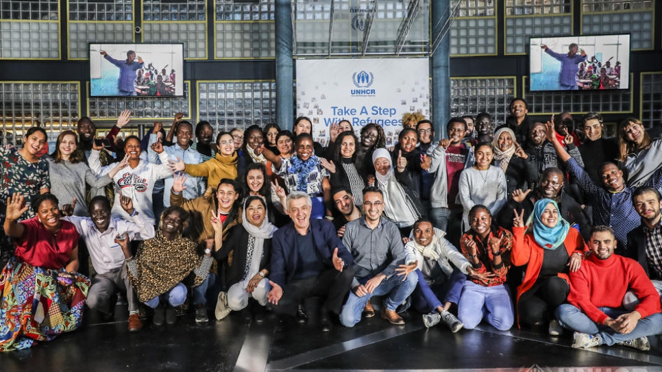 UN High Commissioner for Refugees Filippo Grandi (front-centre, crouching) meets a group of 70 young refugees attending the Global Refugee Forum in Geneva.