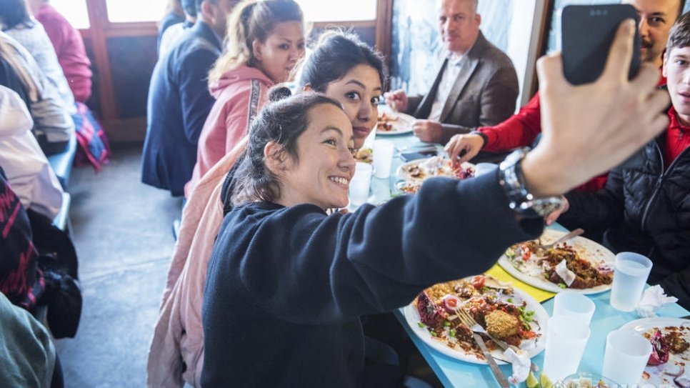 The popular restaurant at the lakefront Bains des Pâquis provides lunch for a group of refugees – attended by UN High Commissioner for Refugees Filippo Grandi – during the Global Refugee Forum in Geneva.