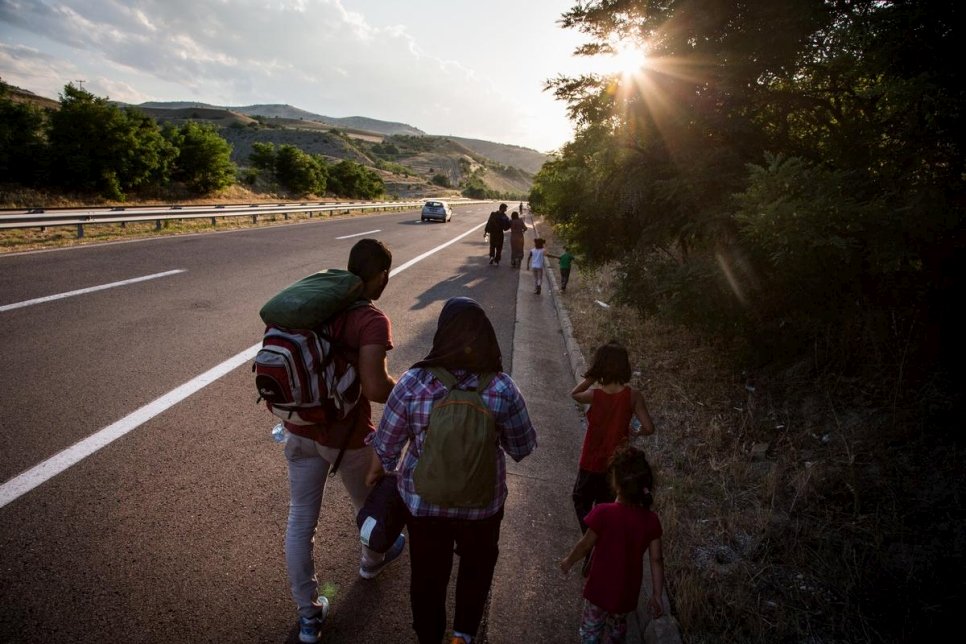 A Syrian refugee family walk along the main highway, near Veles, Macedonia. Hundreds of refugees and migrants are traveling through Macedonia everyday on their way north through the Balkans, in an attempt to reach western Europe. They use whatever means of transport is available including trains and bicycles, however many end up walking the entire distance.