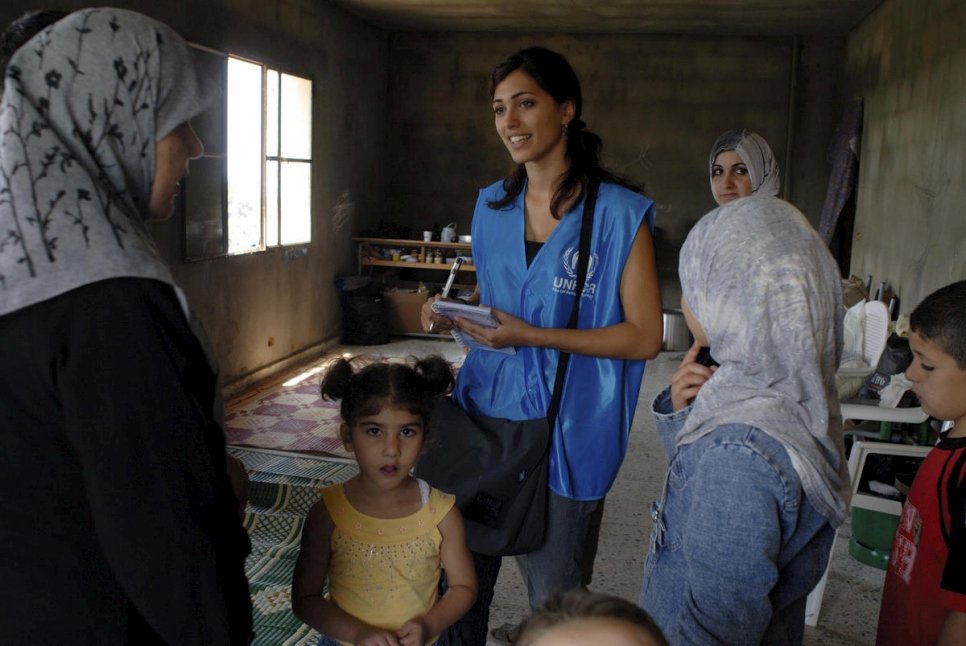 Lebanon / IDPs / Mouaysara community. Diana Menhem, 19, UNHCR field team talks to displaced people living in a school. / UNHCR / J. Matthews / August 2006