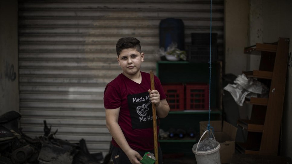 Thirteen-year-old Syrian refugee Bakr works in a supermarket and delivers food to support his family.