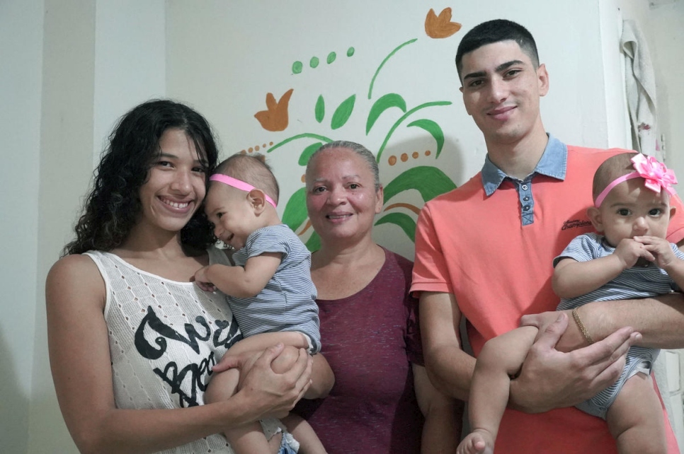 Venezuelan refugee María* poses for a portrait with her family in Medellín, Colombia. Kept inside by coronavirus stay-at-home orders, they are struggling to pay for basics like groceries and rent.