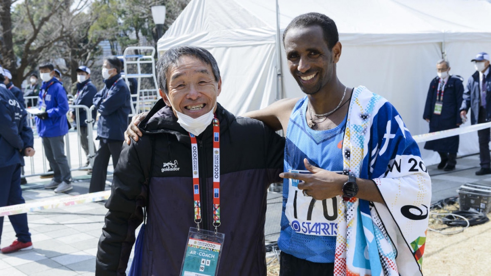 After the race Yonas celebrates with his coach in Japan, Naruyosi Karasawa.