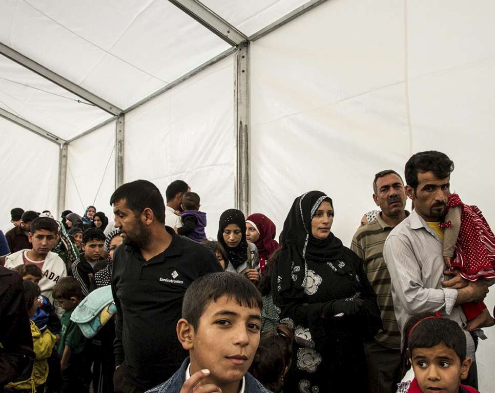 Syrian refugees queue up to be registered at the UNHCR registration offices in Amman, Jordan