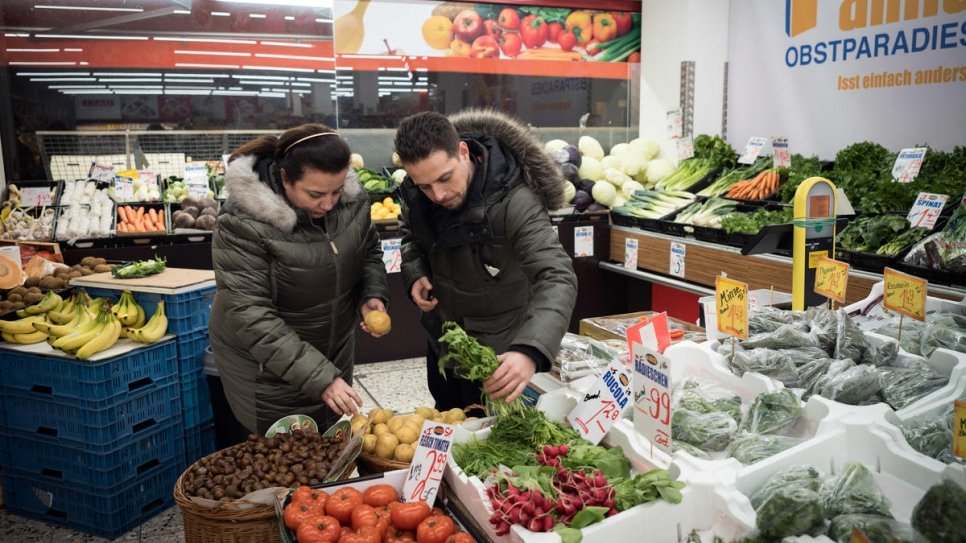 Syrian refugee Salma Al Armarchi, 53, and her son Fadi Zain, 32, buy fresh food in a Turkish supermarket near her kitchen in Berlin.