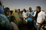 UNHCR Goodwill Ambassador Julien Clerc meets with Sudanese refugees at the temporary site of Mahamata, eastern Chad. March 2, 2004.