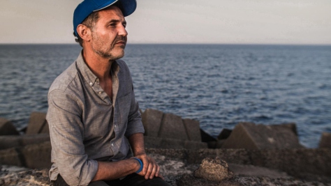 Italy. UNHCR Goodwill Ambassador Khaled Hosseini meets refugees who have survived the perilous sea crossing to Europe