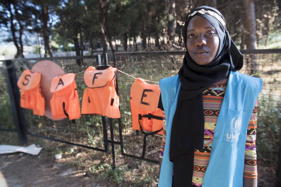 Emi stands in front of a selection of lifejackets. Many now line the beaches of Lesvos. 