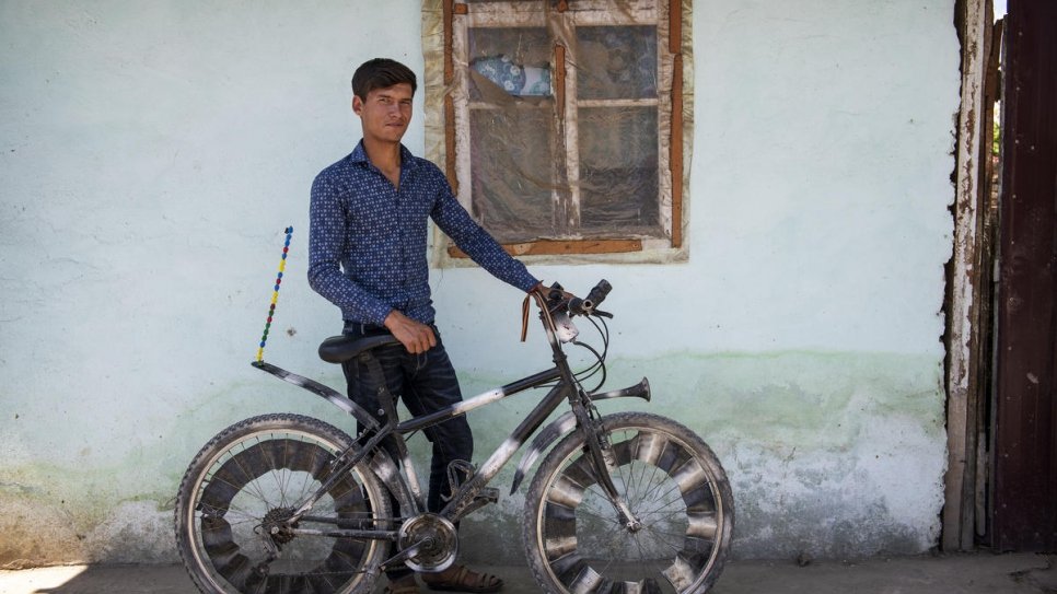 Nazir with the customized bicycle he uses to ride around the local area. 