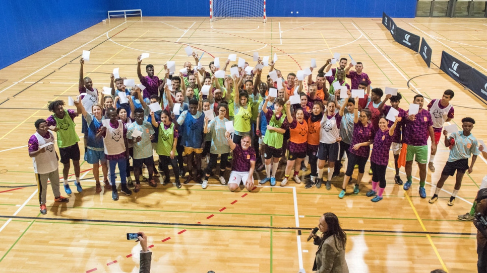 White card moment. Refugees join local players, diplomats and UN staff in teams competing in an indoor football tournament as part of the Global Refugee Forum
