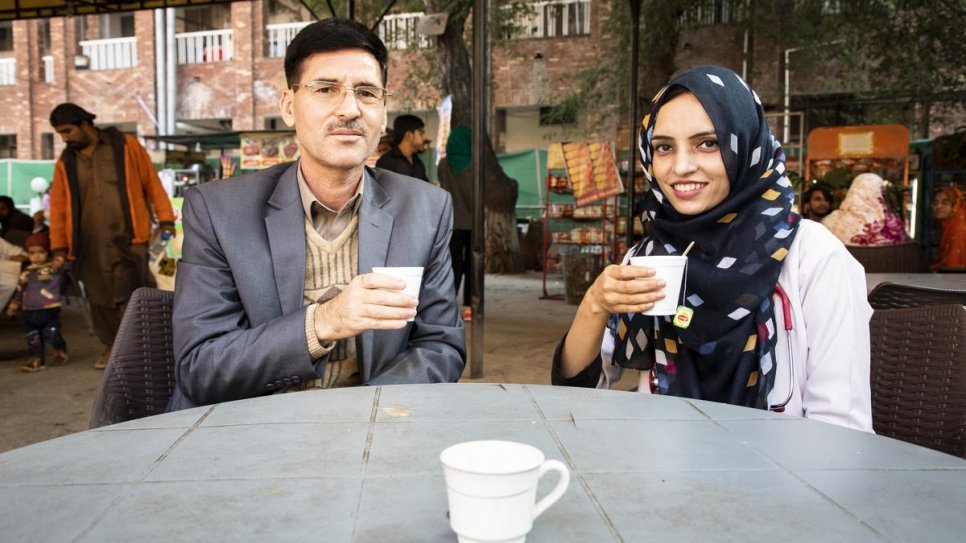 Saleema takes a short tea break outside the hospital with her father, Abdul Rehman.