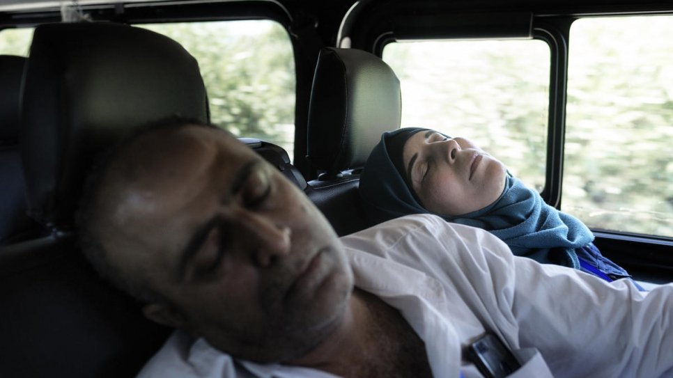 Ammar Issa, 48, and his wife Hanadi, 39, Palestinian refugees from Syria, sleep during the drive from Fiumicino Airport to their new home in Rome.