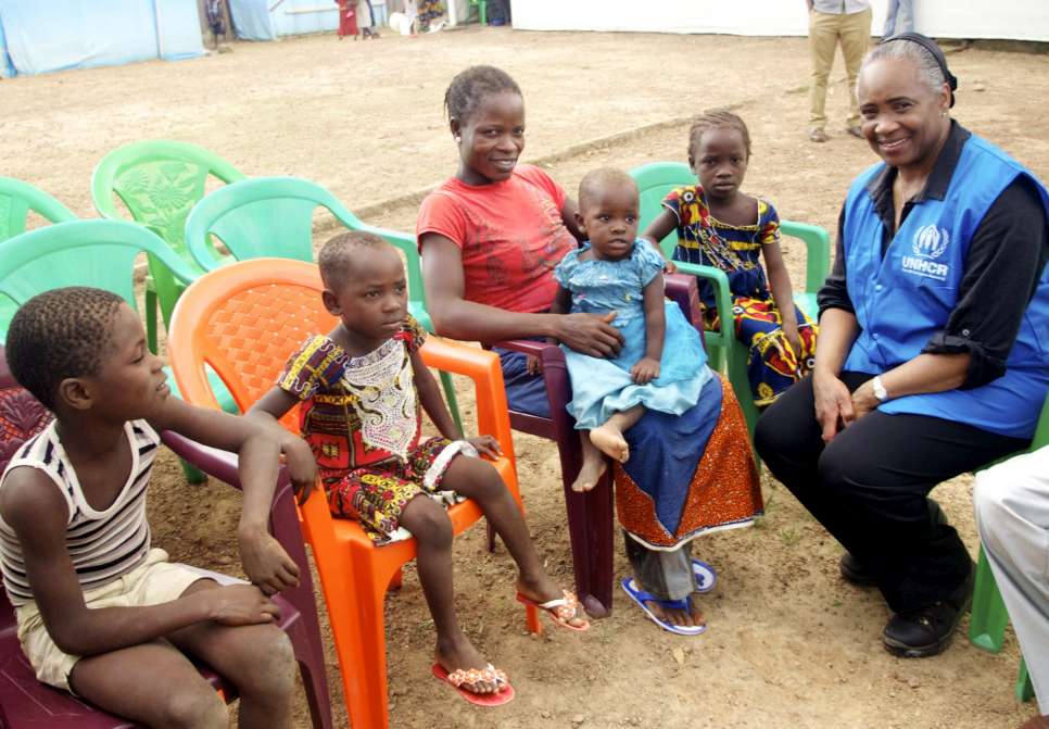 Goodwill Ambassador Barbara Hendricks talks to a mother and children in the transit camp on the border of Liberia, Cote D'Ivoire. July 2014.