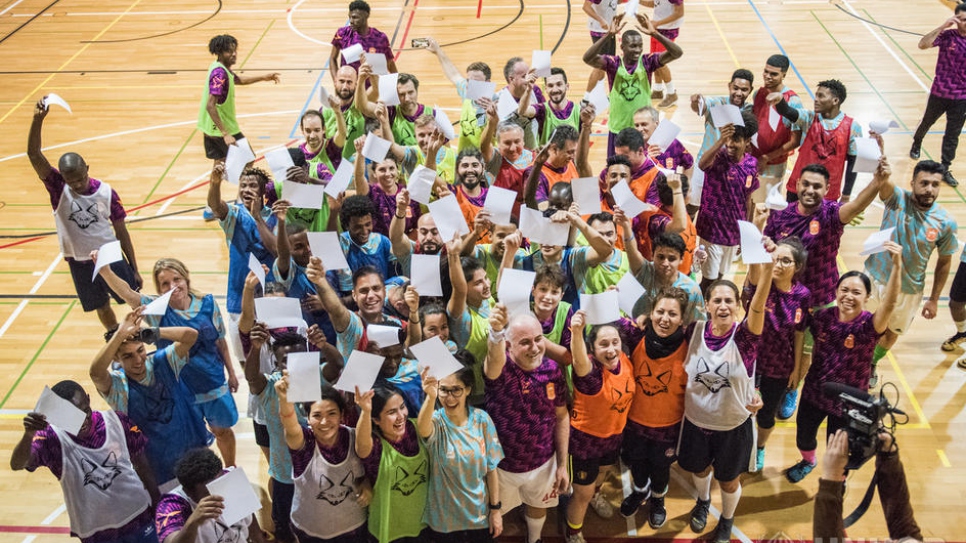 Refugees join local players, diplomats and UN staff in teams competing in an indoor football tournament at the 2019 Global Refugee Forum in Geneva.