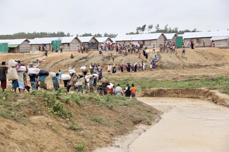 UNHCR staff and partners in Cox's Bazar, Bangladesh, relocate a group of Rohingya refugees from areas in the Kutupalong settlement at risk of landslides and floods to safer shelters in the Camp 4 Extension site.