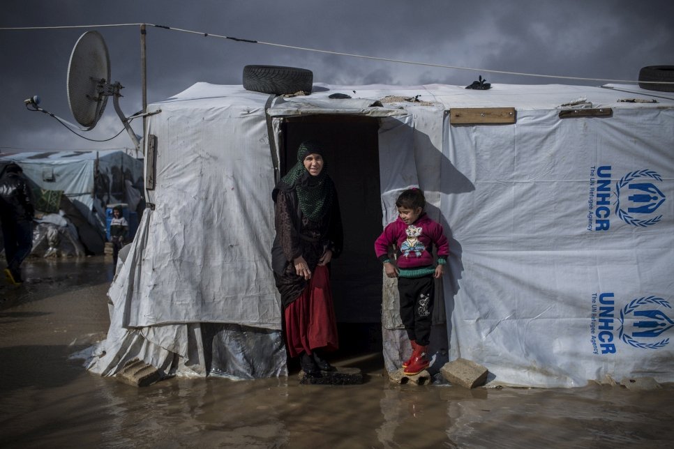 Portrait of Nuria and her daughter Ajar, Syrian refugees from Deir ez-Zor, outside their flooded home at the informal settlement of Dalhamiya in Bekaa Valley. They have been in Lebanon for the last 4 years and a half.