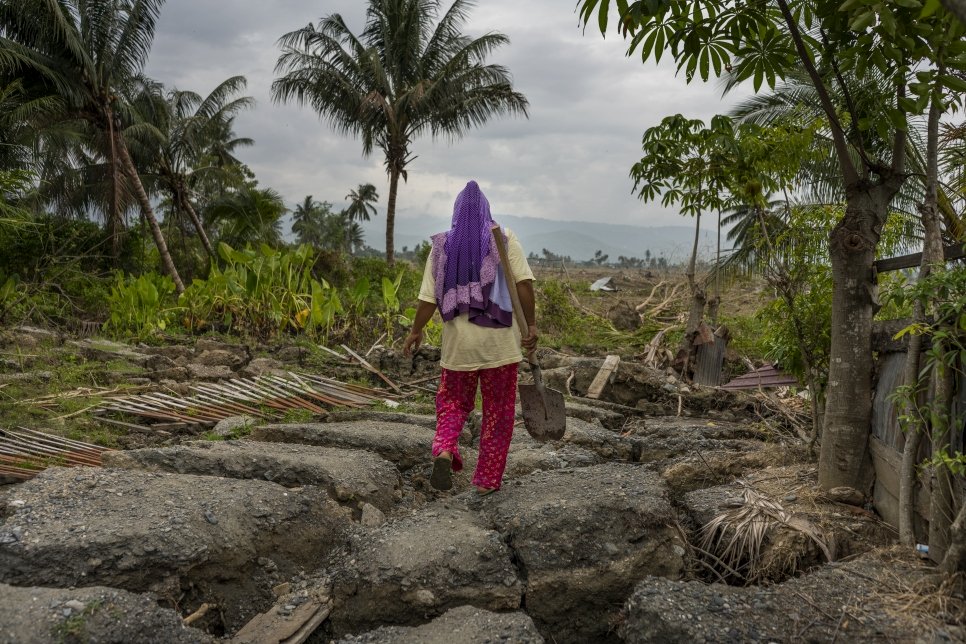 Earthquake survivor, Since, surveys the damage around her destroyed house in Petobo village, Palu, Central Sulawesi, Indonesia. The house was shifted 300 metres away from its original location by the liquefaction that followed a powerful tsunami.