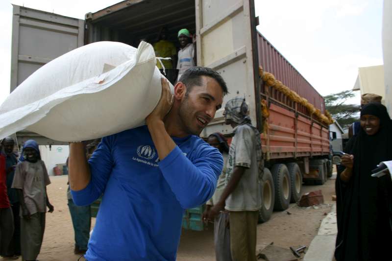 Jesús Vázquez helps unload bags of food at a warehouse in Hagadera camp, Dadaab, Kenya