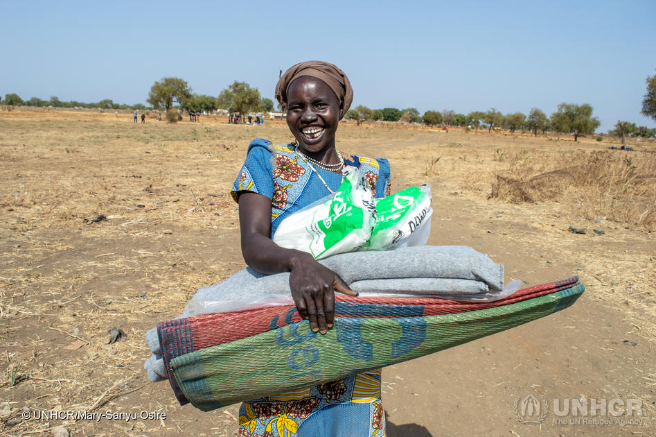 A woman from South Sudan's refugee-hosting community collects her UNHCR core relief items in Bunj, Maban county.