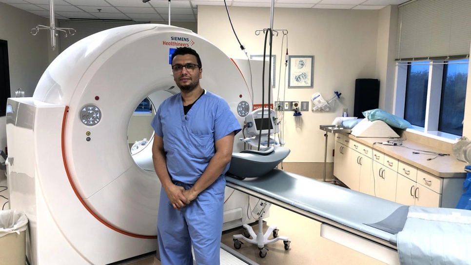 Former Syrian refugee Heval Kelli is a cardiology fellow at a large hospital in Atlanta, Georgia. He has also been volunteering at a COVID-19 drive-through testing site.
