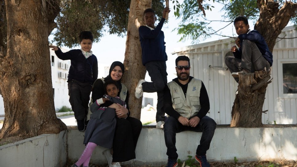 Staff and children pose for a photograph in the grounds of the GDF facility.