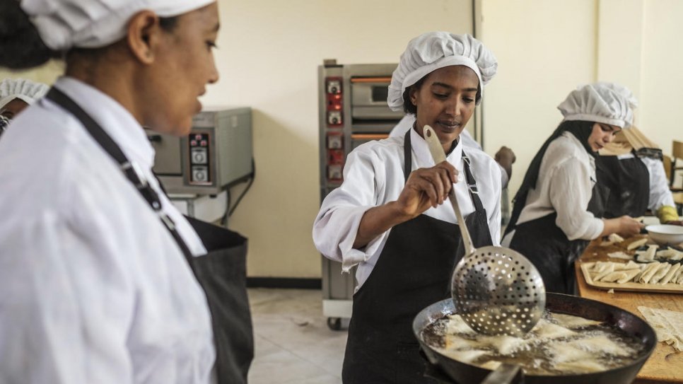 Yanchinew (centre), from Ethiopia, prepares food as part of a cooking course at Nefas Silk Polytechnic College in Addis Ababa.